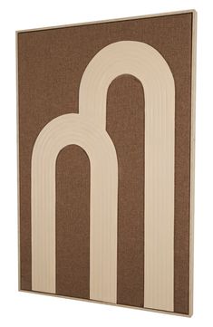 a brown and white wall hanging with two arches