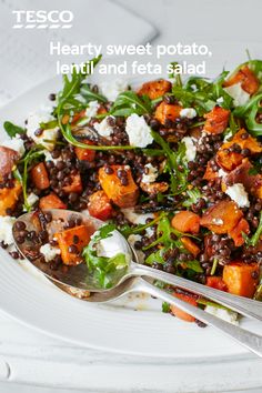 a white plate topped with lentils and sweet potato salad