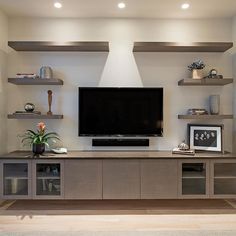 a flat screen tv sitting on top of a entertainment center