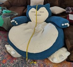 a crocheted stuffed animal sitting on top of a couch