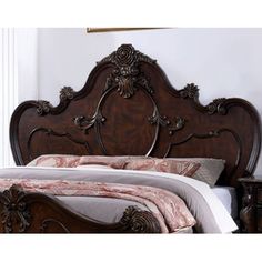 a bed with a wooden headboard and foot board