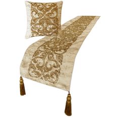 two decorative pillows with tassels on the sides and an intricately embroidered design