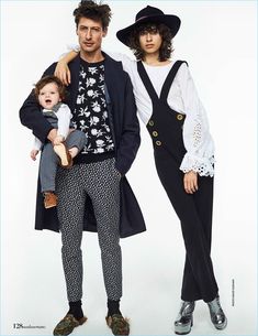 a man, woman and child are posing for a fashion photo in front of a white background