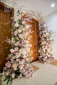 an entrance decorated with pink and white flowers