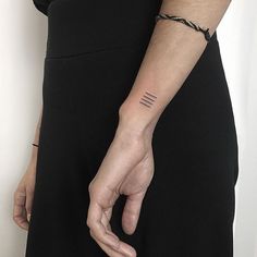 a woman wearing a black dress holding onto her wrist with the word love written on it