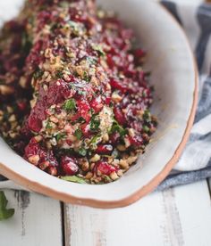 a white bowl filled with food on top of a wooden table