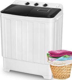 the laundry machine is next to a basket with towels