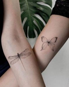 two people with tattoos on their arms holding each other's hands and one has a dragonfly tattoo on it