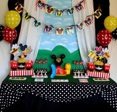 a mickey mouse birthday party with balloons and decorations