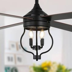 a ceiling fan with two lights hanging from it