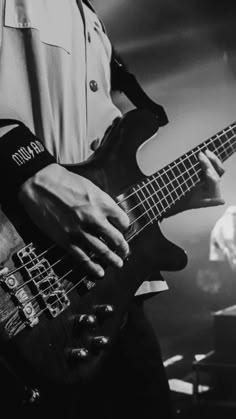 black and white photograph of man playing bass guitar