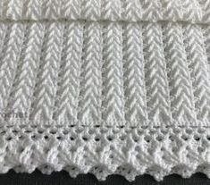 white crocheted blanket on black background