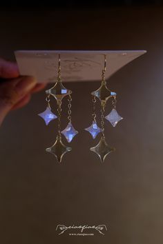 "---- Welcome to CiaoQiao Shop ----- The earrings feature geometric star-shaped moonstone and lemon quartz natural gemstone beads. Each earring consists of a sequence of these stars, with the largest at the top and gradually decreasing in size towards the bottom. The beads are of a reflective gemstone with a multifaceted surface, creating a shimmering effect as they catch the light.  Length including hooks: 2 1/2\" | 6.35cm What does \"14k gold filled\" mean? \"Gold-filled\" is a USA industry st Raspberry Jewelry, Firefly Jewelry, Stars Earrings, Celestial Earrings, Gothic Earrings, Witchy Jewelry, Crystal Jewellery, Geometric Star, Moonstone Earrings