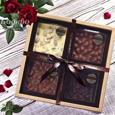 three chocolates in a gift box with red roses