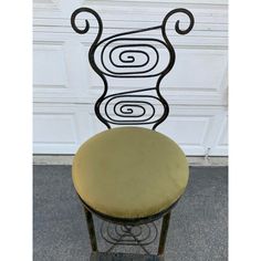 a chair that is sitting in front of a garage door with an artistic design on it