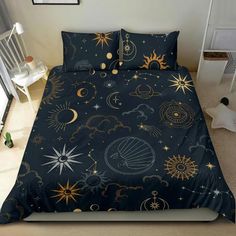 a bed covered in a blue comforter with gold stars and planets on it