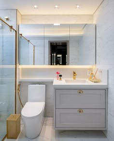 a white toilet sitting next to a bathroom sink under a mirror above a walk in shower