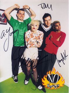 an autographed photo of two men and a woman