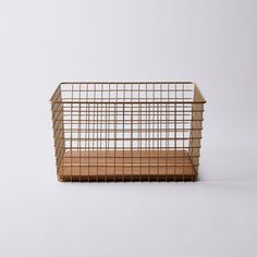 a metal basket sitting on top of a white surface