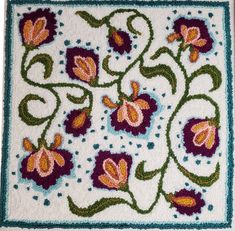 a close up of a rug with flowers on it