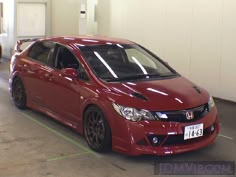 a red car parked in a parking garage