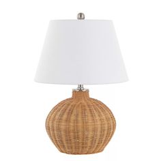 a wicker table lamp with a white shade