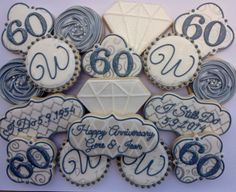 decorated cookies are arranged in the shape of an 80th wedding anniversary and annivers