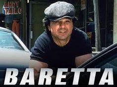 a man leaning on the hood of a car in front of a street sign that reads, roberto