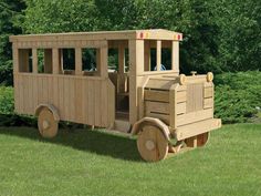 a wooden toy train sitting in the grass