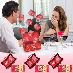 a man and woman sitting at a table with red boxes in front of their faces