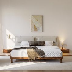 a bedroom with a bed, nightstands and paintings on the wall