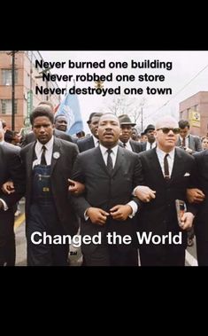 a group of men in suits and ties walking down the street with words that read, never burned one building never robbeded one store never destroyed one town