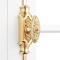 a golden door handle on a white door