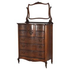 an antique dresser with a mirror on the top and bottom drawer, all in wood