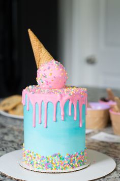 a cake with ice cream and sprinkles on it sitting on a table