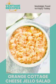 an orange cottage cheese jello salad recipe on a blue and white napkin with spoons