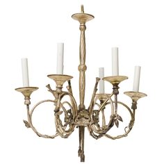 an antique chandelier with six candles on it