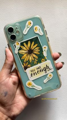 someone is holding up their phone case with the words you are enough on it and flowers