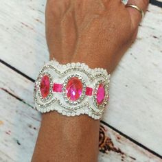 Eye Catching Hot Pink Rhinestone Cuff Bracelet. Made Of White Lace And Lined With White Satin Ribbon And Ties With Hot Pink Satin Ribbon. It Is Embellished With Hot Pink Rhinestone Brooches And Trimmed With Clear Rhinestones. Measures 6" Long And Is 1 3/4" Wide. It Has Satin Ribbon Adjustable Ties To Fit Most Wrists. White Crystal Bracelets With Sparkling Stones, Adjustable White Crystal Bracelet With Bling, White Crystal Bracelet With Rhinestones For Party, White Crystal Bracelet With Bling, Bedazzled White Crystal Jewelry, White Party Bracelets With Rhinestones, White Crystal Bracelet With Rhinestones As Gift, Adjustable White Jeweled Jewelry, White Party Cuff Bracelet