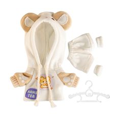 a teddy bear in a white jacket and hat with clothes on the bottom, next to it's hanger