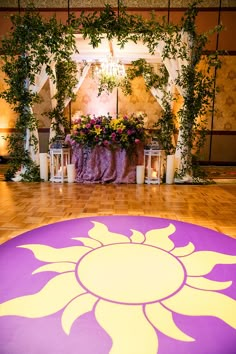 the floor is decorated with flowers, candles and greenery for an outdoor wedding ceremony