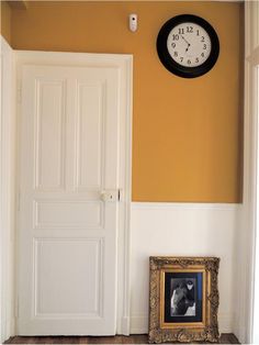 an open door with a clock on the wall