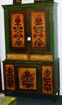 an old dresser with painted flowers on it