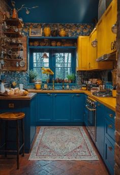 a kitchen with blue cabinets and yellow counter tops is seen through an archway leading to the dining room