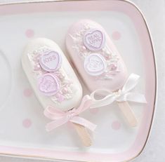 two soaps on a pink and white tray with polka dot design around the edges