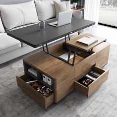 a living room with a couch, coffee table and laptop on top of the table