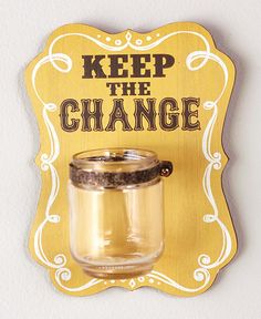 a sign that says keep the change in front of a jar filled with sand and spices