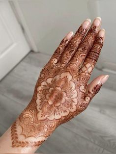 a woman's hand with hennap on it, showing the intricate design