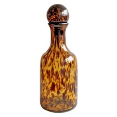 a brown and black glass bottle on a white background