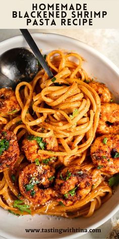 a white bowl filled with shrimp pasta and parmesan cheese, topped with parsley